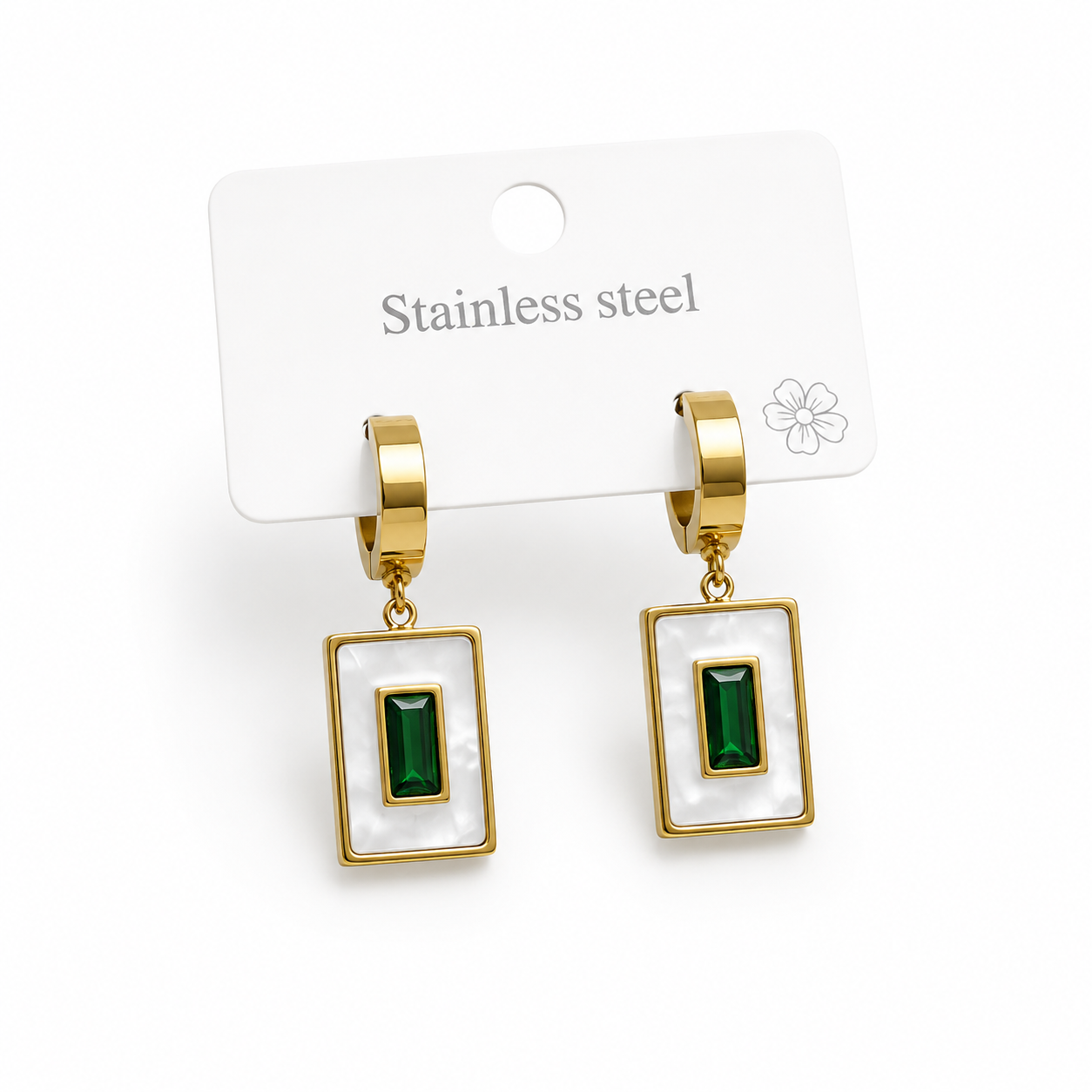 Gold-tone drop earrings featuring a rectangular white frame with a green gemstone-inspired centerpiece displayed on a stainless steel jewelry card.