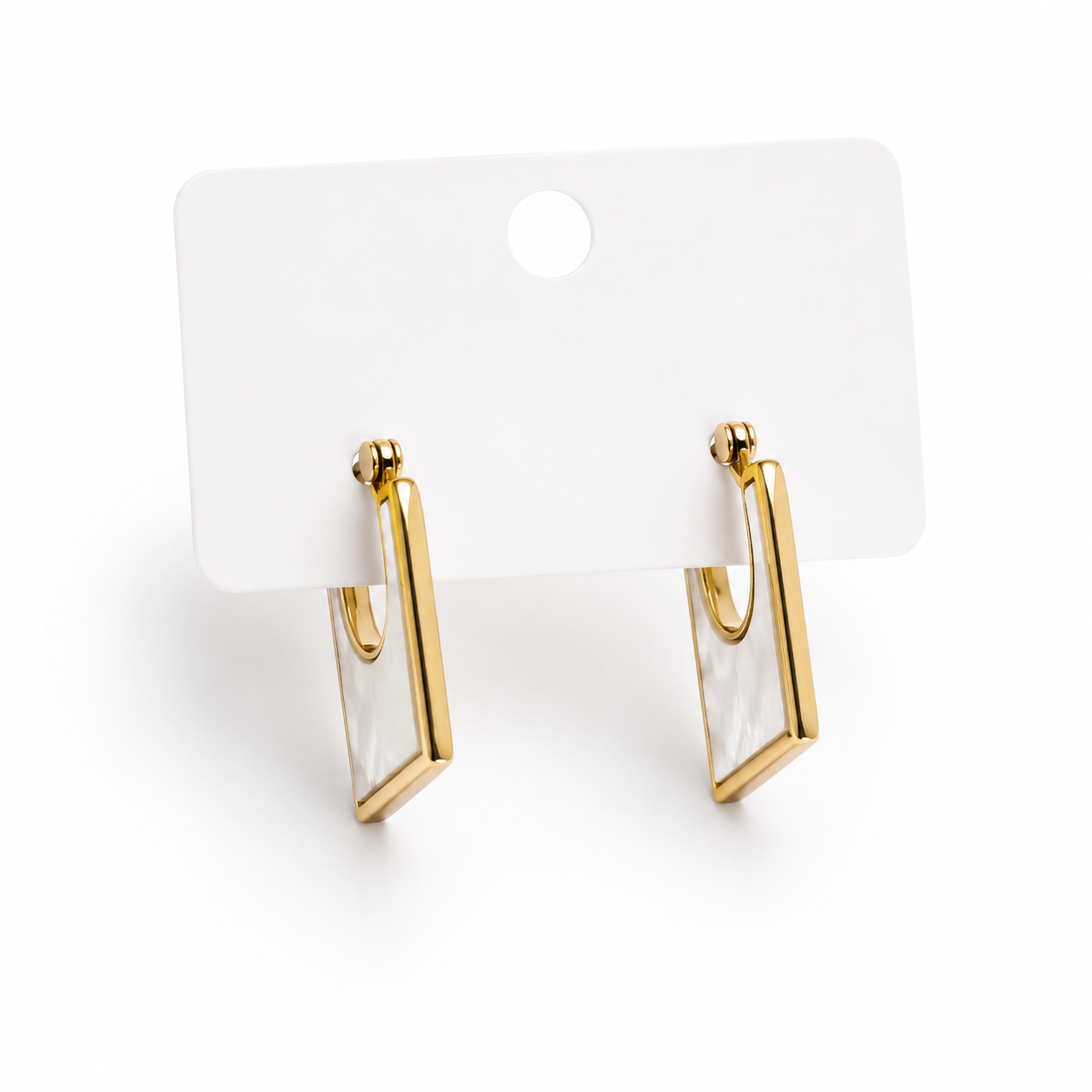 Gold-tone rectangular drop earrings featuring a pearl-inspired center detail displayed on a jewelry card.