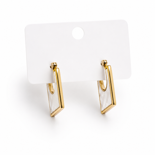 Gold-tone rectangular drop earrings featuring a pearl-inspired center detail displayed on a jewelry card.