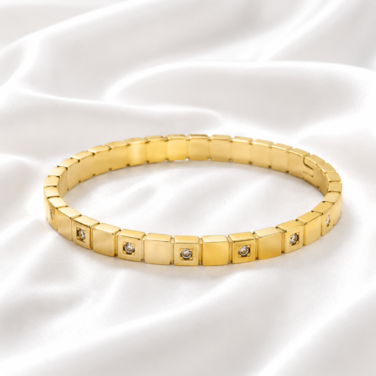 Gold crystal link bangle on white satin background