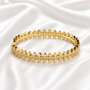 Gold crystal crown bangle on white satin background