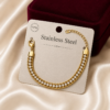 Luxury gold-tone crystal rope chain bracelet displayed on a premium stainless steel jewellery card