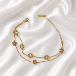 Luxury double-layer gold crystal bracelet with star charms on white satin background