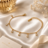Luxury gold crystal charm bracelet displayed on a white satin background