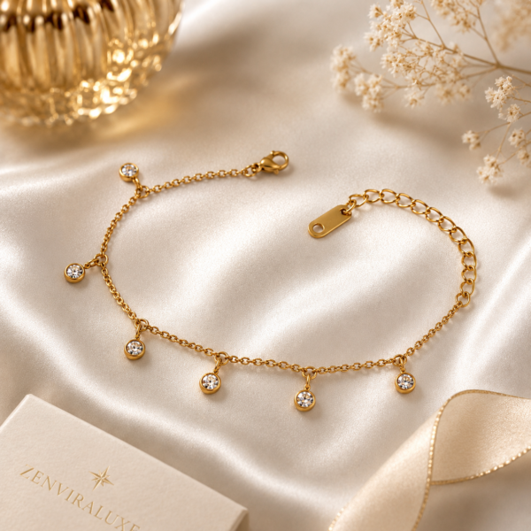 Luxury gold crystal charm bracelet displayed on a white satin background