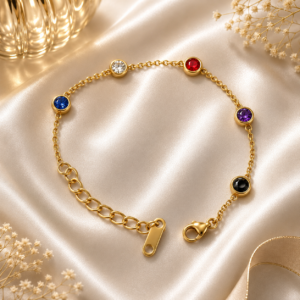 Luxury gold bracelet with multi-color crystal accents displayed on white satin background