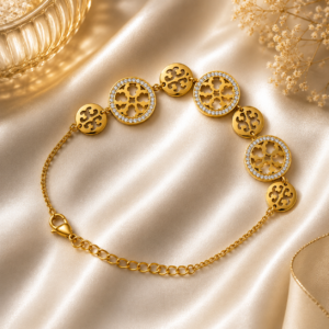Luxury gold crystal medallion bracelet displayed on a white satin background