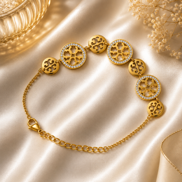 Luxury gold crystal medallion bracelet displayed on a white satin background