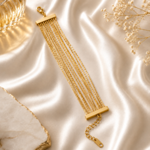 Luxury multi-layer gold chain bracelet displayed on a white satin background