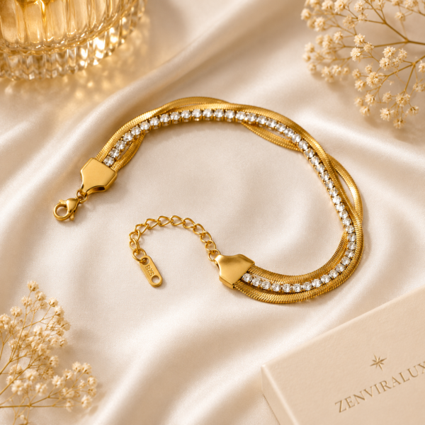 Luxury gold-tone crystal snake chain bracelet displayed on a white satin background