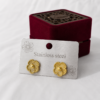 Vintage gold flower stainless steel ear studs displayed on a jewelry card.