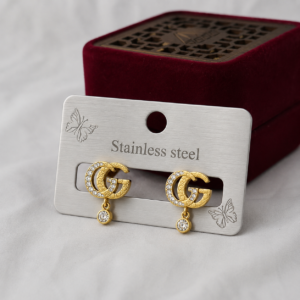 Gold-tone Double G stainless steel ear studs with crystal accents and dangling crystal charms.