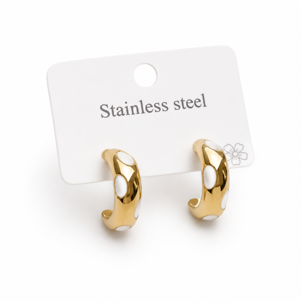 Gold-tone stainless steel hoop earrings with white enamel accents displayed on a jewelry card.