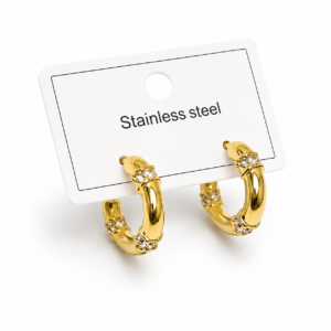 Gold-tone stainless steel hoop earrings with crystal knot details displayed on a white jewelry card.