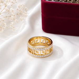 Gold stainless steel floral cutout band ring displayed on a white satin background.